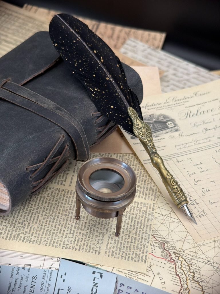 Magnifier, journal, and pen representing evidence-led discovery